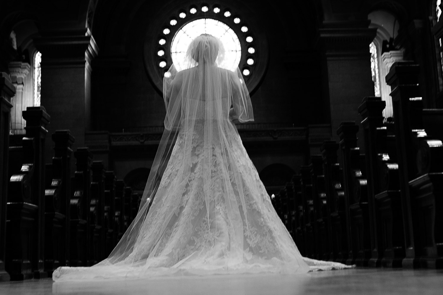 bride in front of stained glass window at The Basilica of Saint Mary