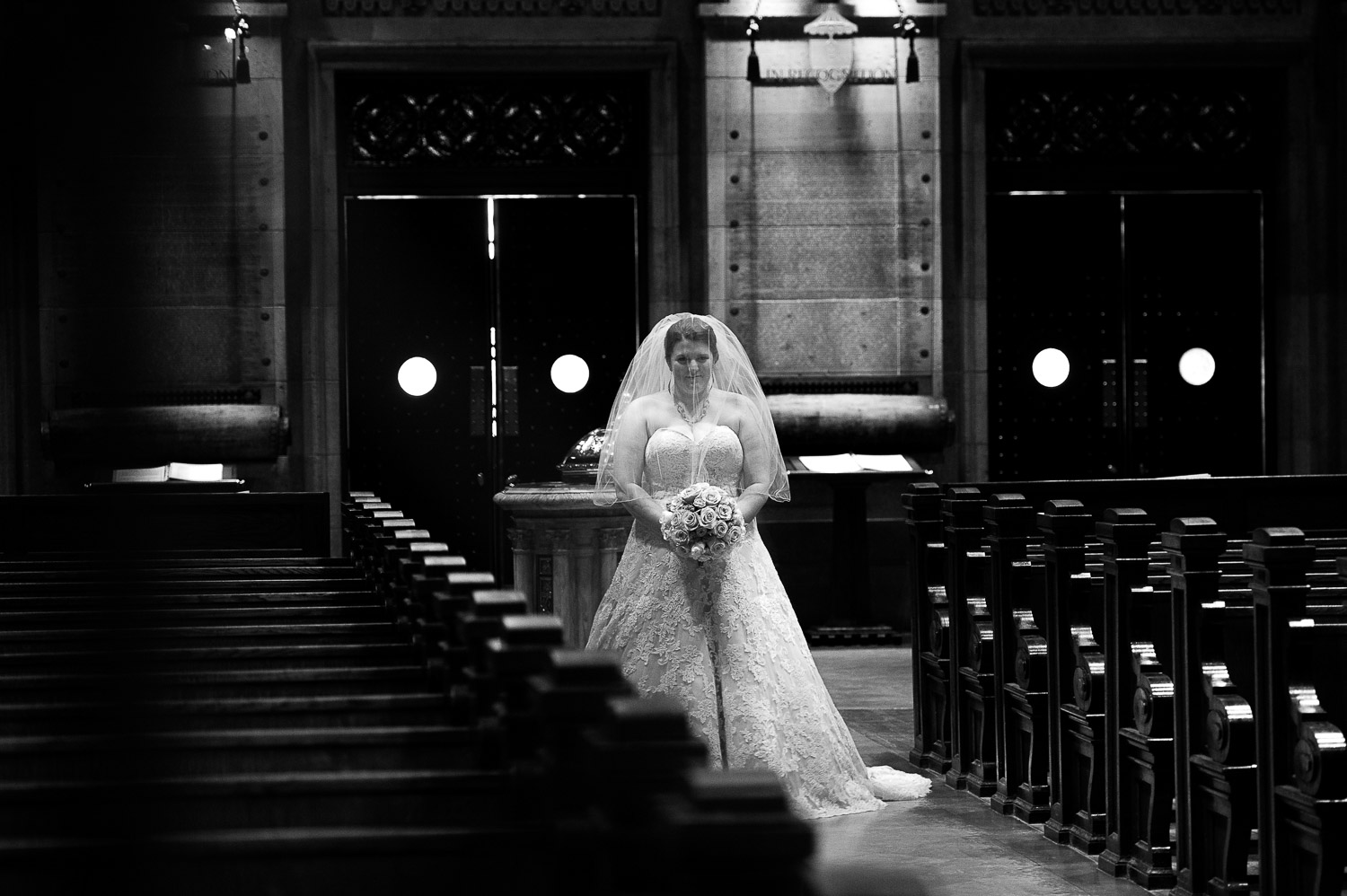 bride walking down the aisle at church to meet her groom for the first look at The Basilica of Saint Mary