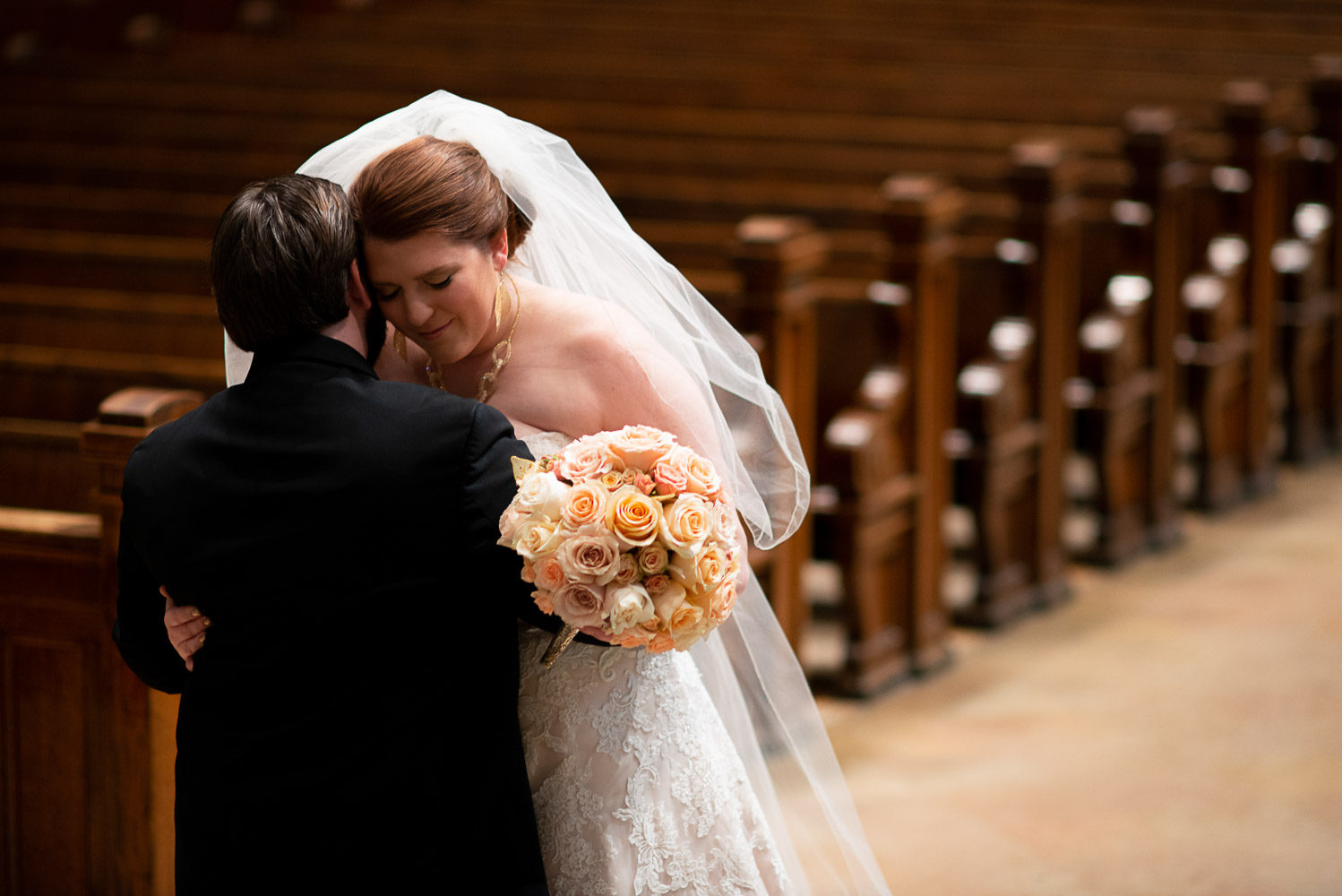 bride hugging her groom at The Basilica of Saint Mary on their wedding day