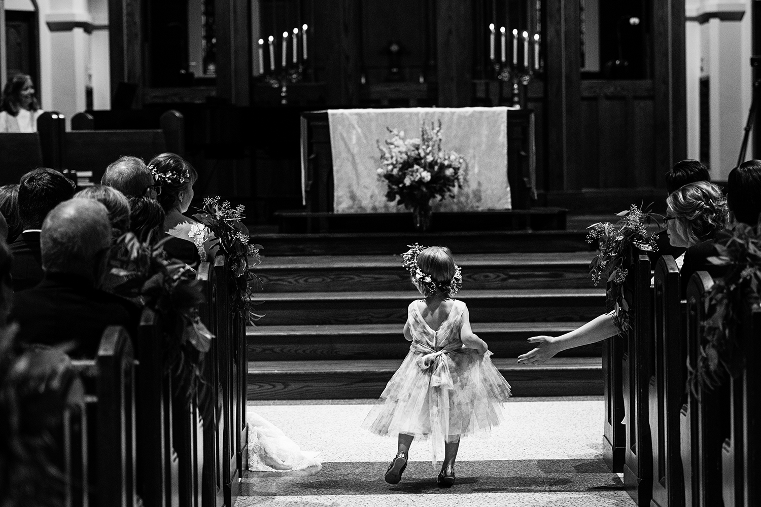 flower girl in the aisle during the ceremony