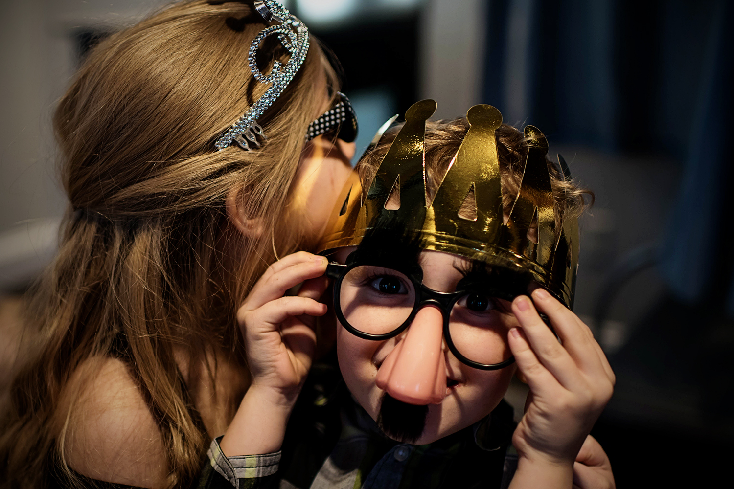 kids playing with props at a photo booth at a wedding