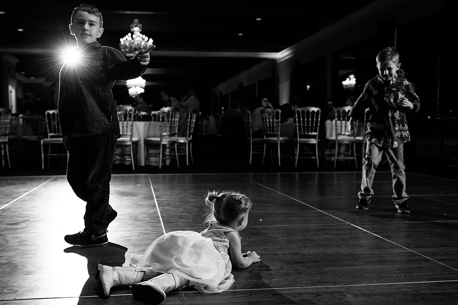 flower girl laying on the dance floor during the reception