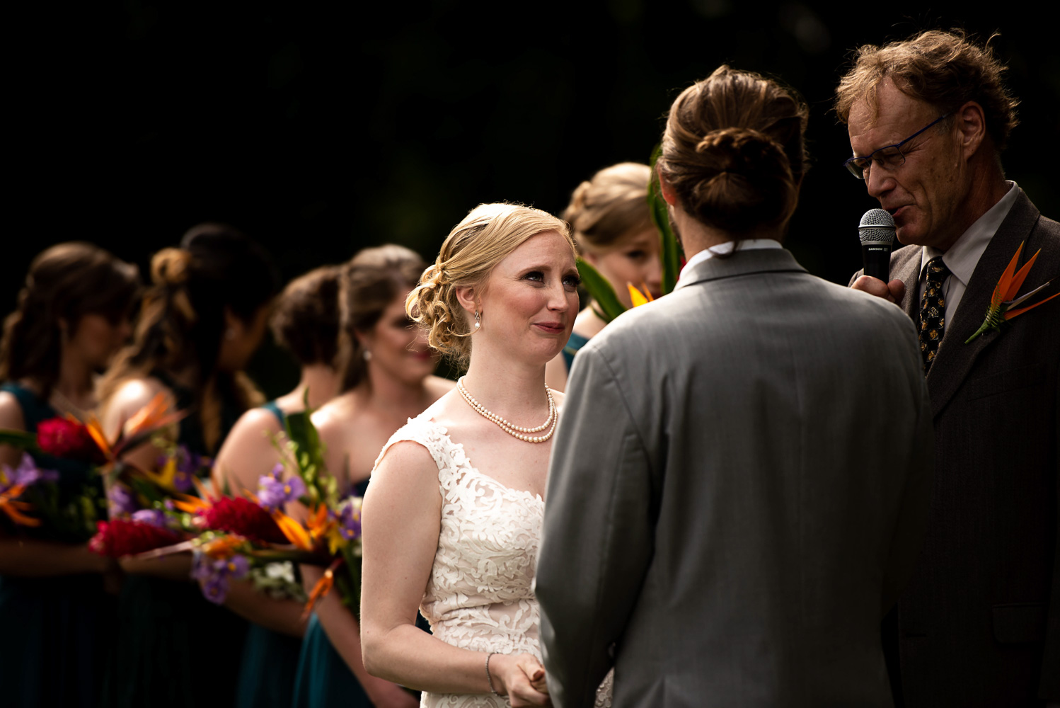 bride reading her vows to the groom during their Minnesota summer backyard wedding