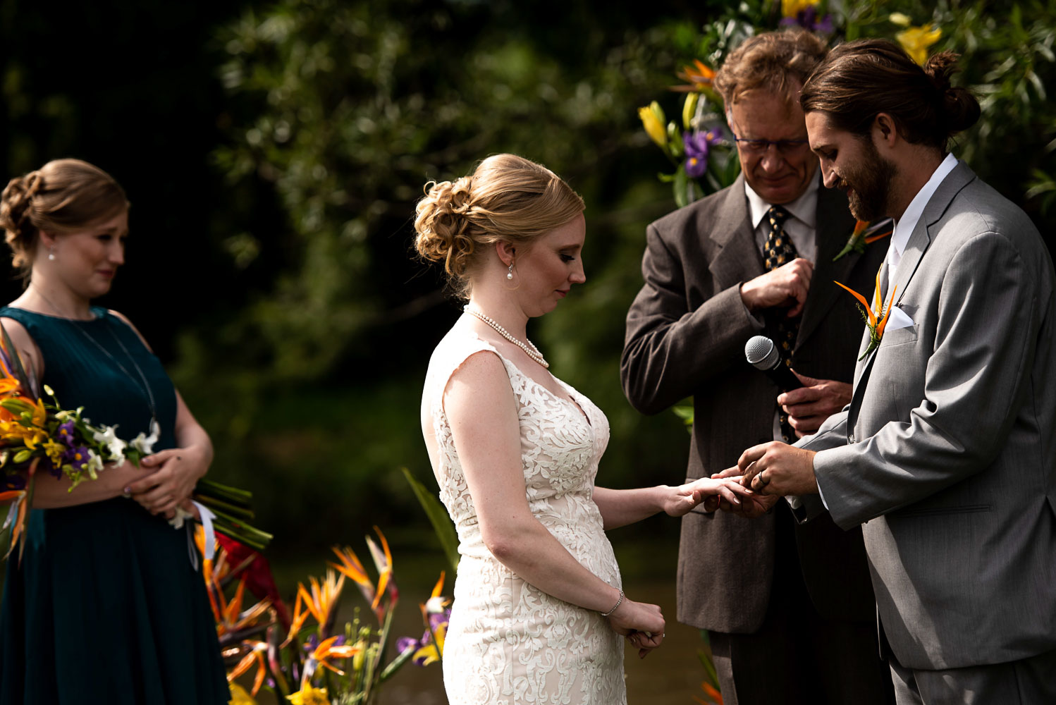 groom putting the ring on the bride during the wedding ceremony in Minnesota
