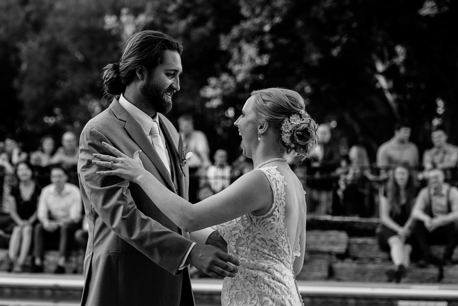 bride and groom smiling at each other during their first dance at their summer wedding