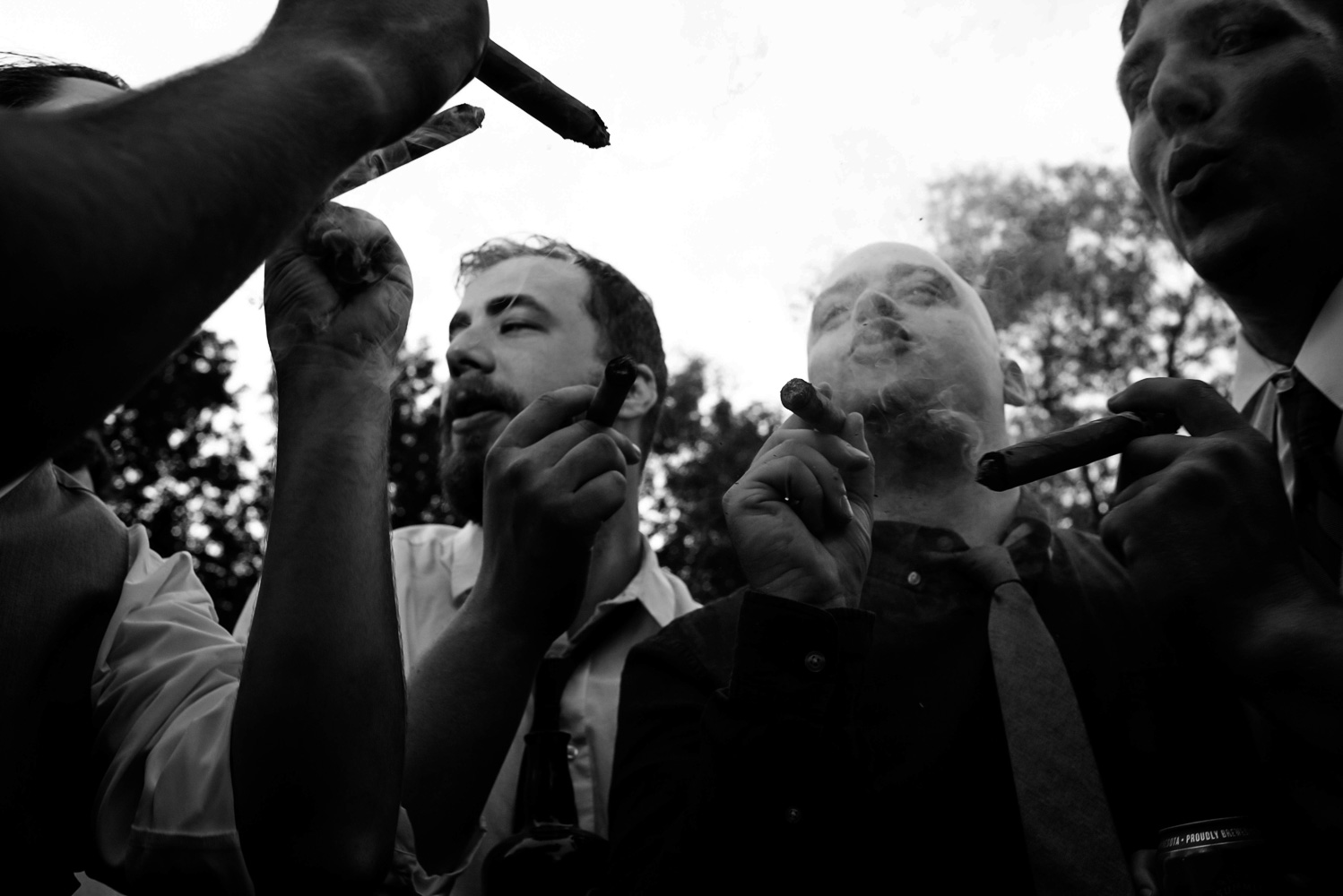 groom and the groomsmen smoking cigars