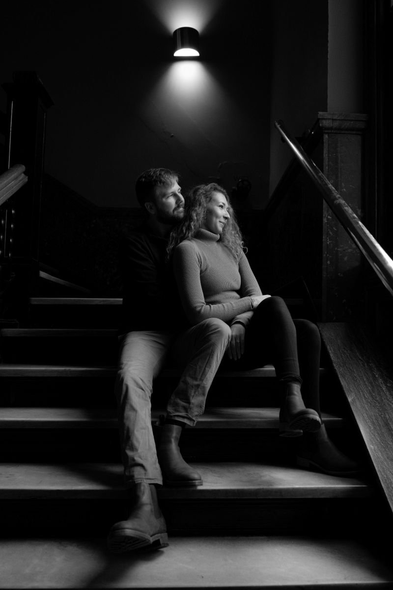 a copule sitting on the stairs together at landmark center