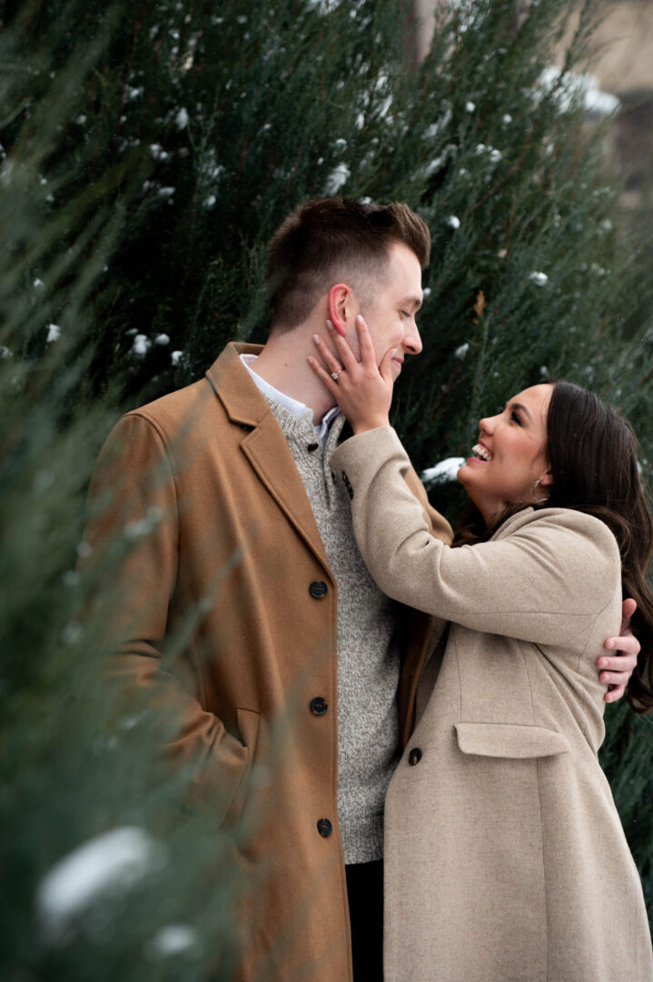 Couple embracing in field of flowers during St. Anthony Main engagement session.