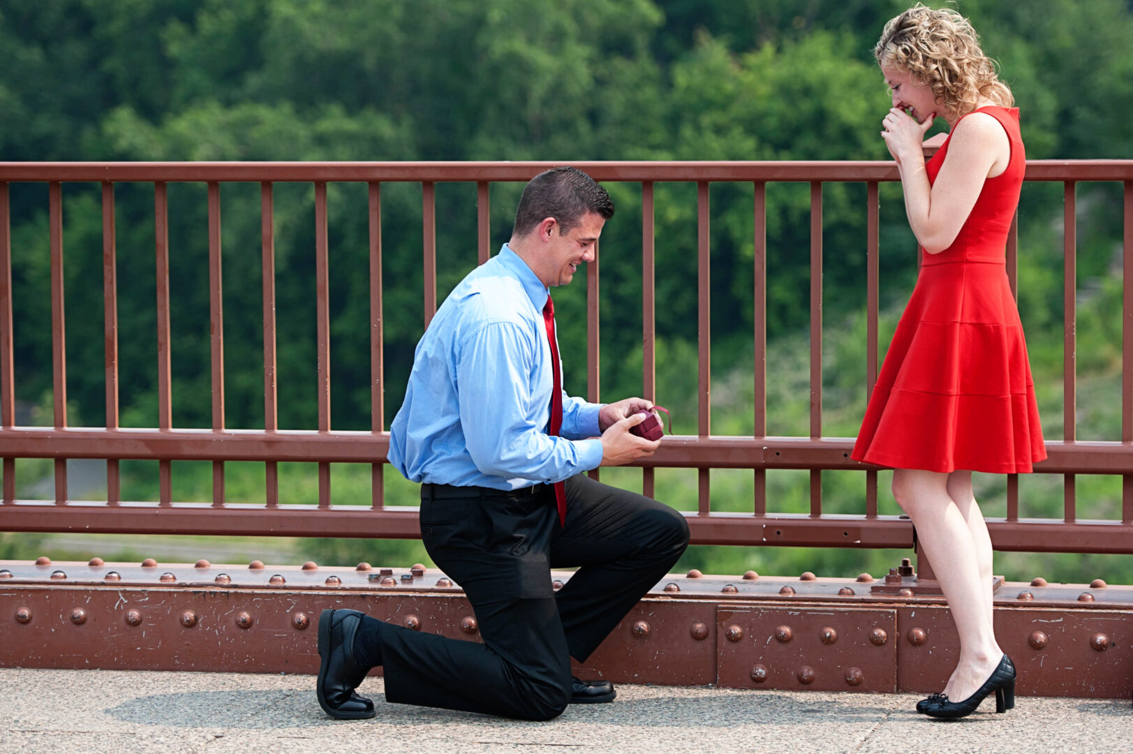 Man proposes on bridge at St. Anthony Main.