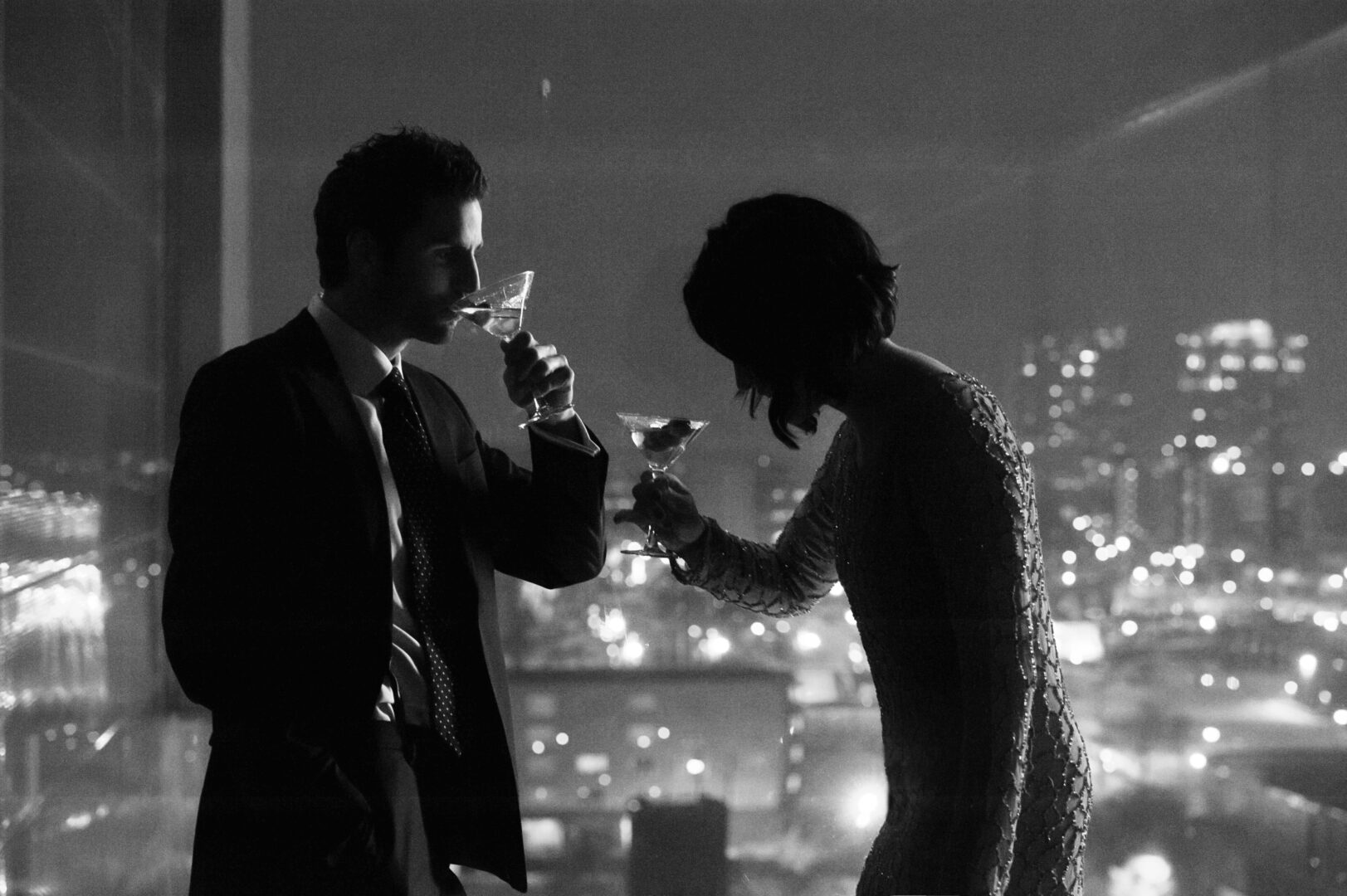 Couple drinking martinis with skyline behind them through the window at the Guthrie Theater Minneapolis Minnesota