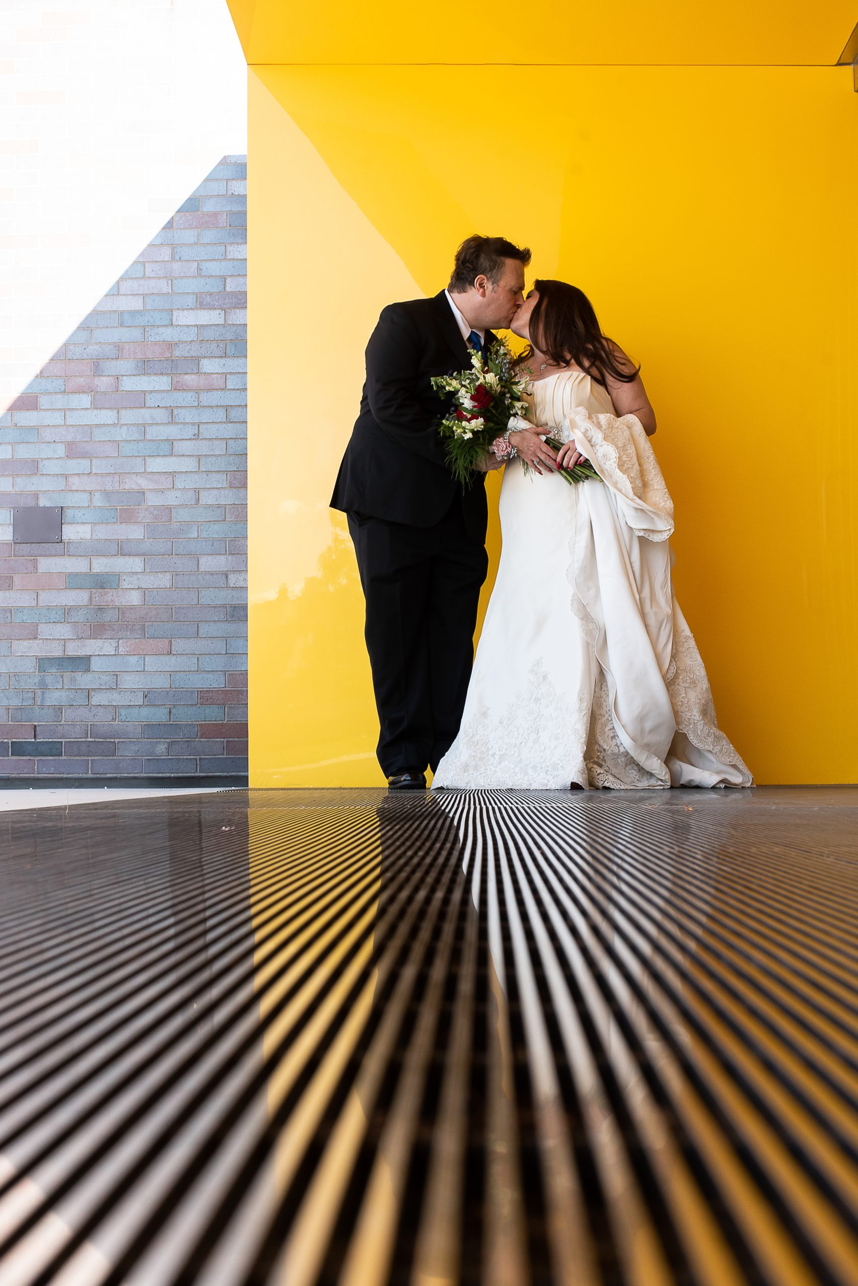 a man and woman kissing inside the walker arts center on the day of their wedding
