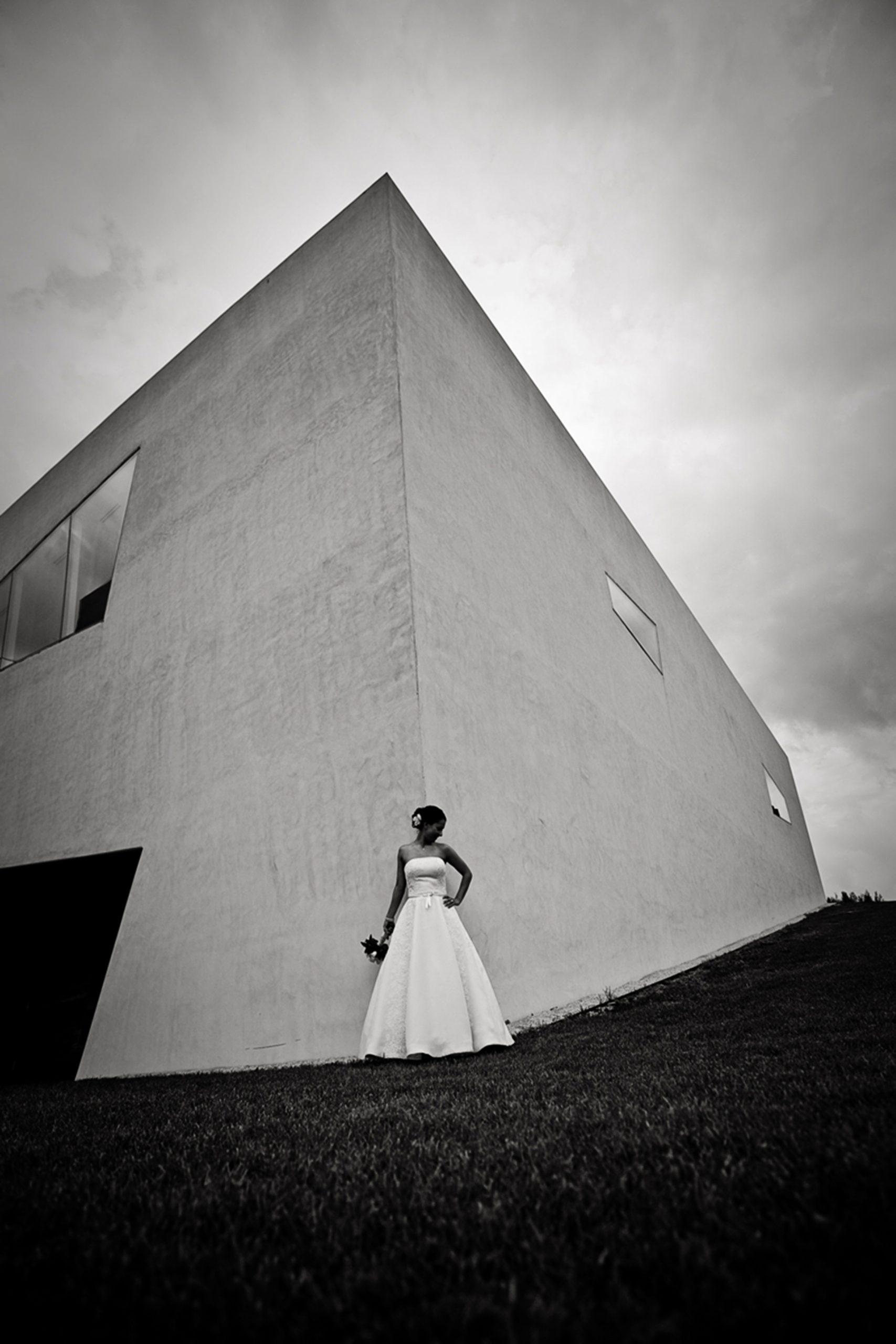 a bride standing in front of the walker arts center taking a wedding portrait