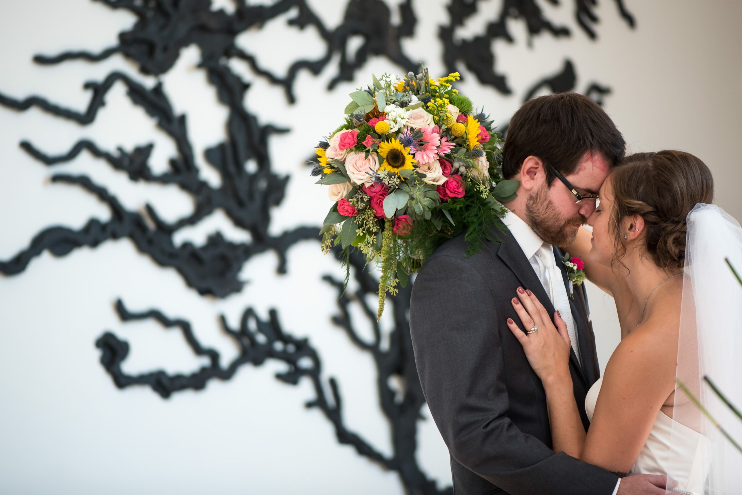 a bride and groom at the Weisman Art Museum taking a wedding portrait